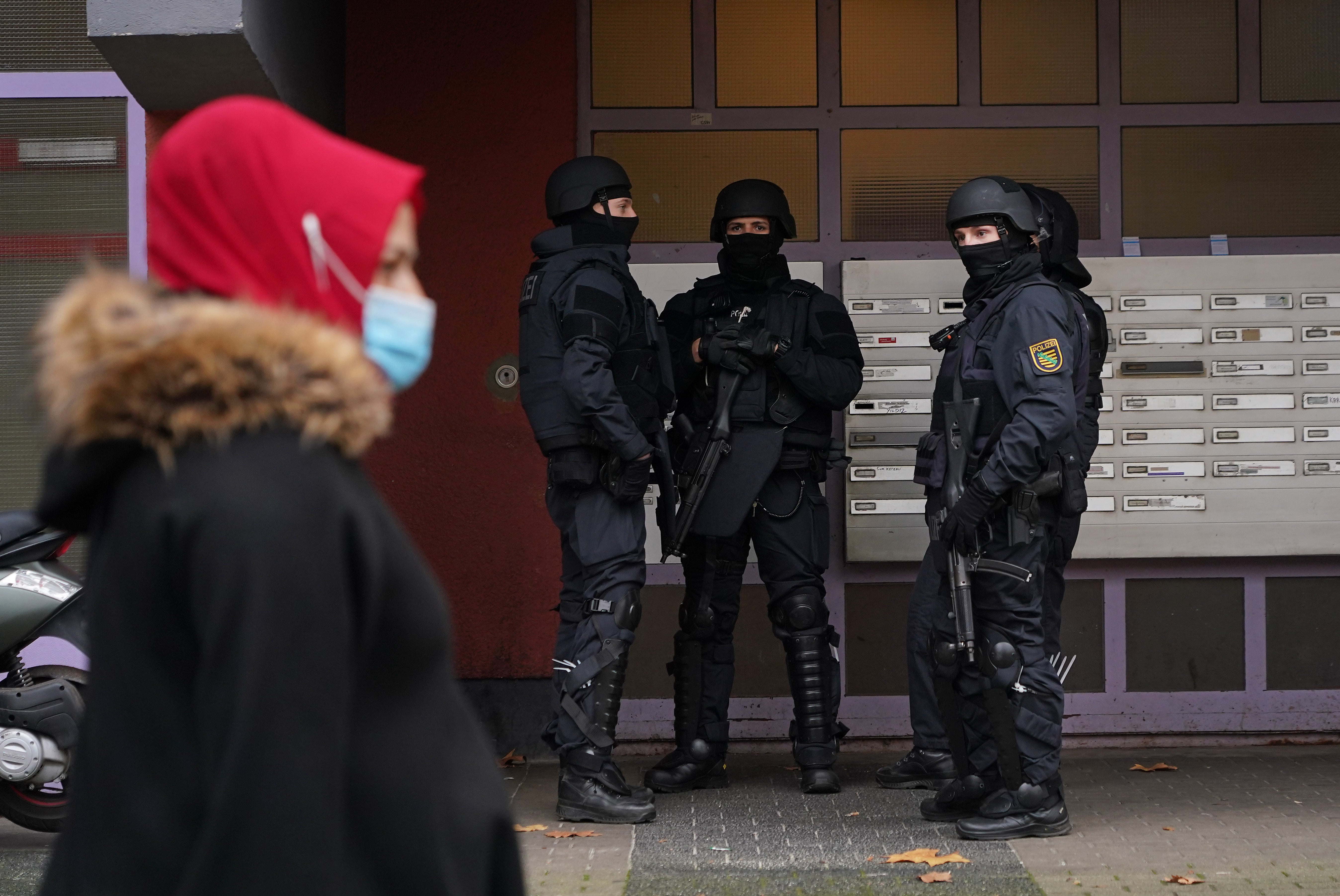 Heavily-armed police standing outside an apartment building in Kreuzberg district
