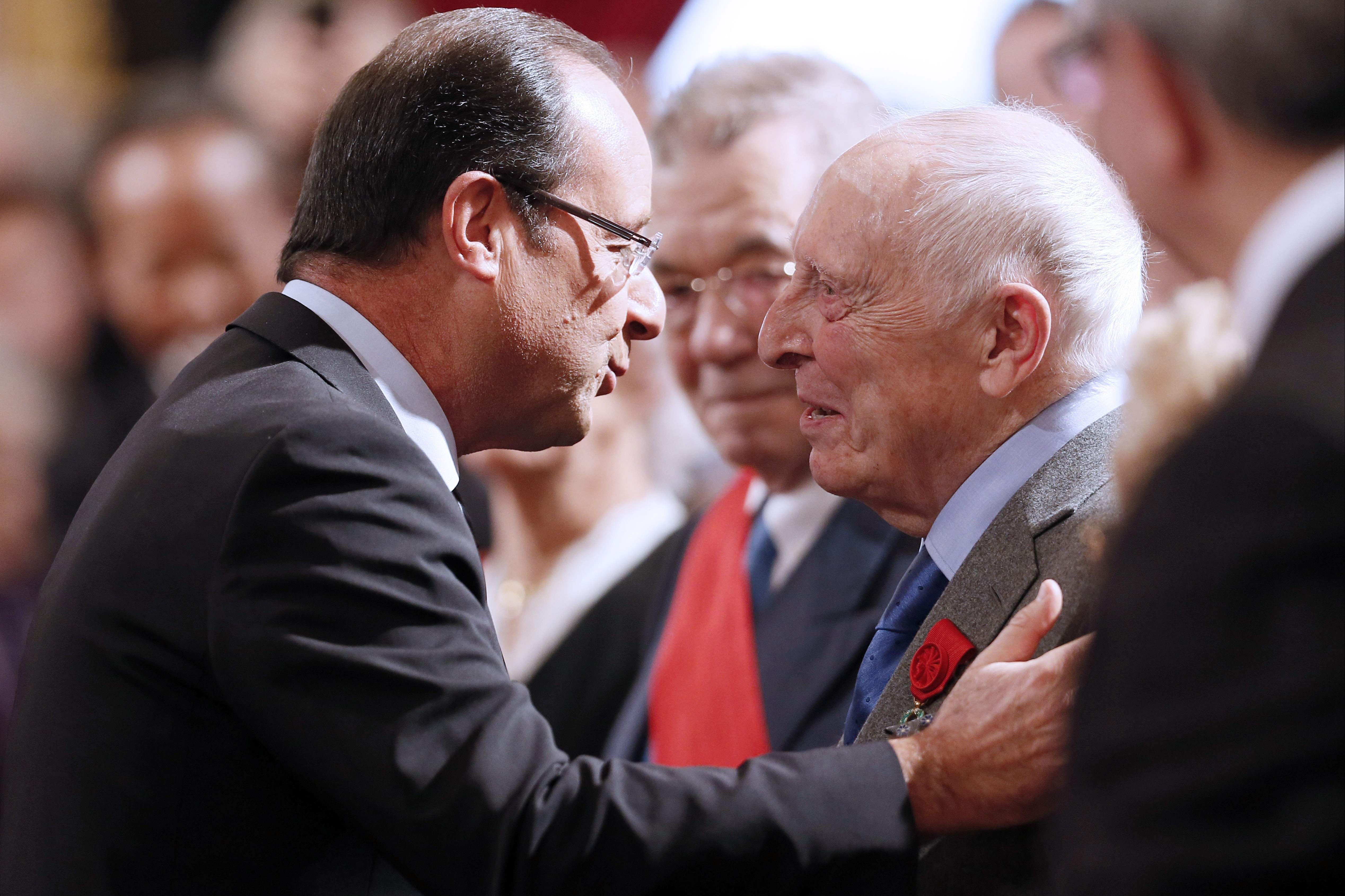 Cordier is greeted by the then French president Francois Hollande during a ceremony in Paris in 2012