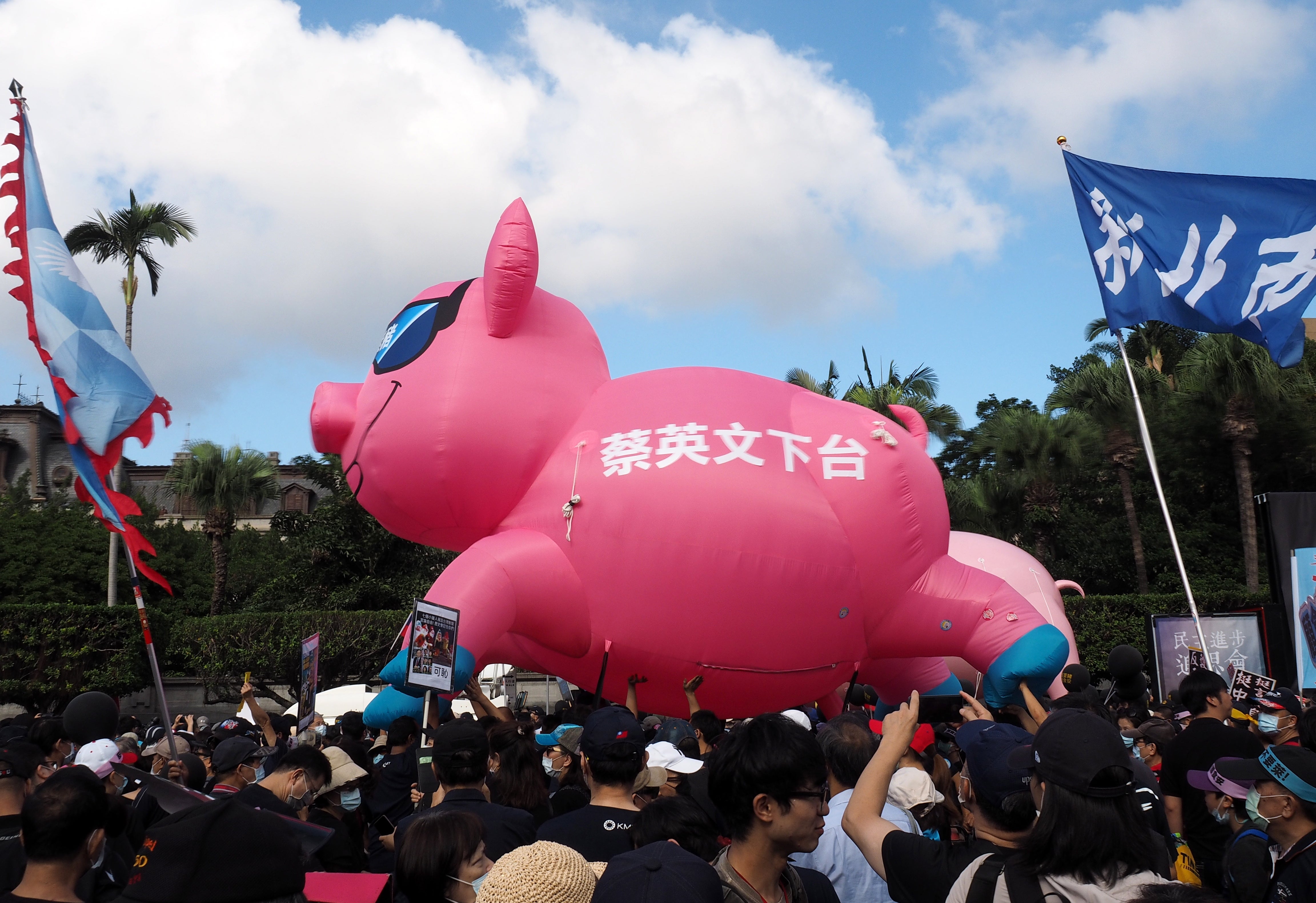 Taiwanese, holding an inflated pig with Chinese words ‘Tsa Ing-wn Step Down,’ march to the Presidential Office Building in Taipei, earlier this month (EPA/DAVID CHANG)