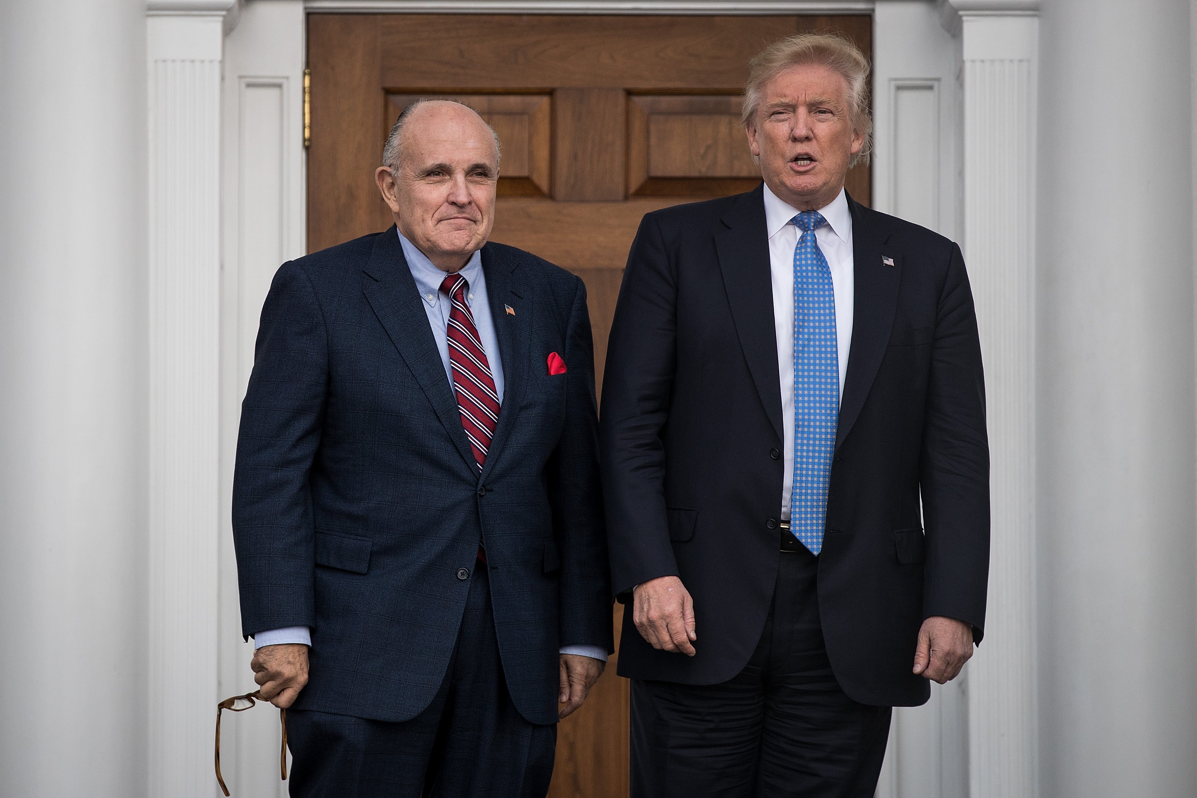 Former New York City mayor Rudy Giuliani stands with president-elect Donald Trump before their meeting at Trump International Golf Club, on 20 November 2016 in Bedminster Township, New Jersey