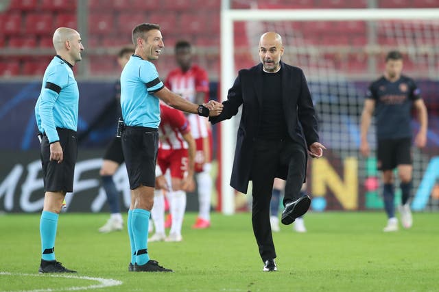 Pep Guardiola speaks with the referee