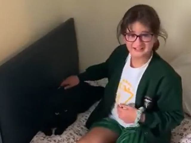 Screen grab from footage issued by Cats Protection of 10-year-old Katya Harmon, from Woking, being reunited with her cat Timmy after he had been missing for nine months