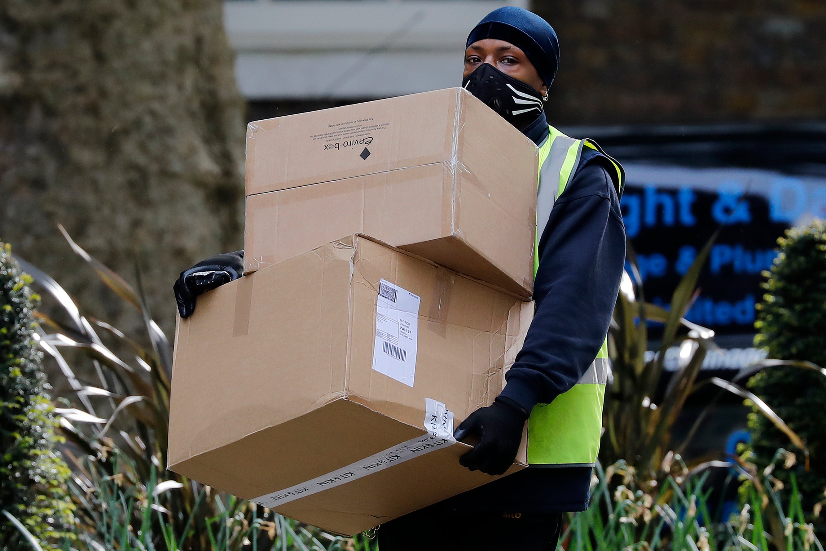 A Hermes delivery courier carries boxes