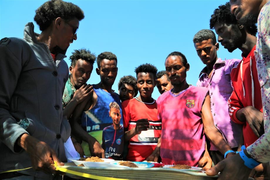 Ethiopians fleeing intense fighting in their homeland of Tigray, receive food in the neighbouring Sudanese Um Rakuba Refugee Camp, Gedaref State, Sudan.