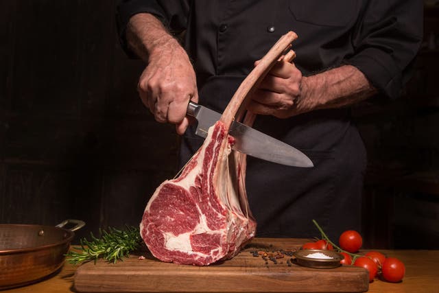 A chef cuts a ribeye steak. Greenpeace has urged countries to reduce meat consumption to help tackle the climate crisis