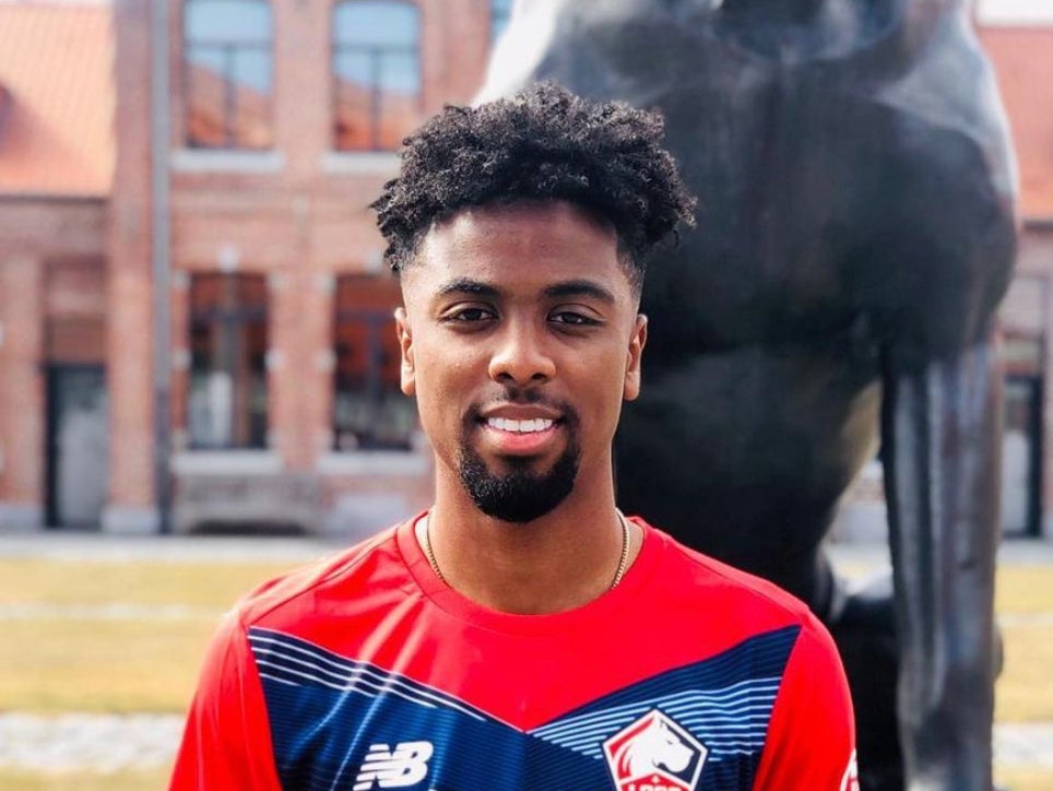 Angel Gomes poses after signing a long-term contract with Ligue One side Lille