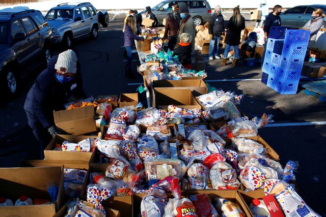 People line up in their cars in the parking lot of St. James Presbyterian Church in Littleton, Colorado to receive food donations from Food Bank of the Rockies ahead of Thanksgiving