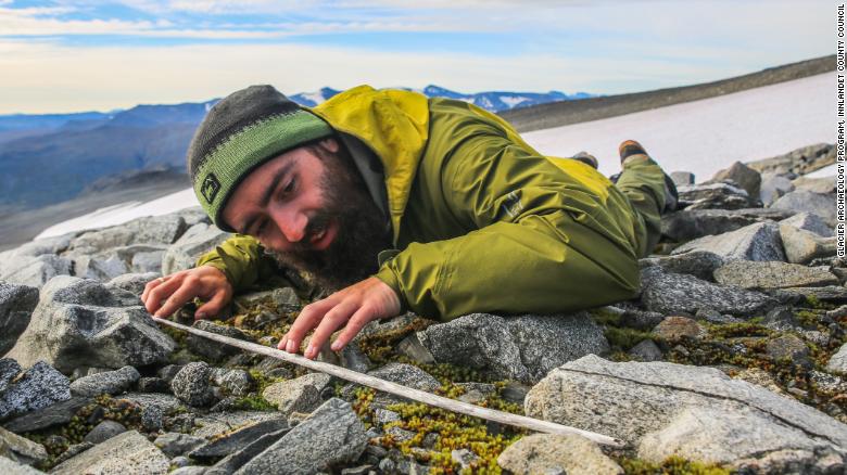 An archaeologist surveys a glacier in Norway