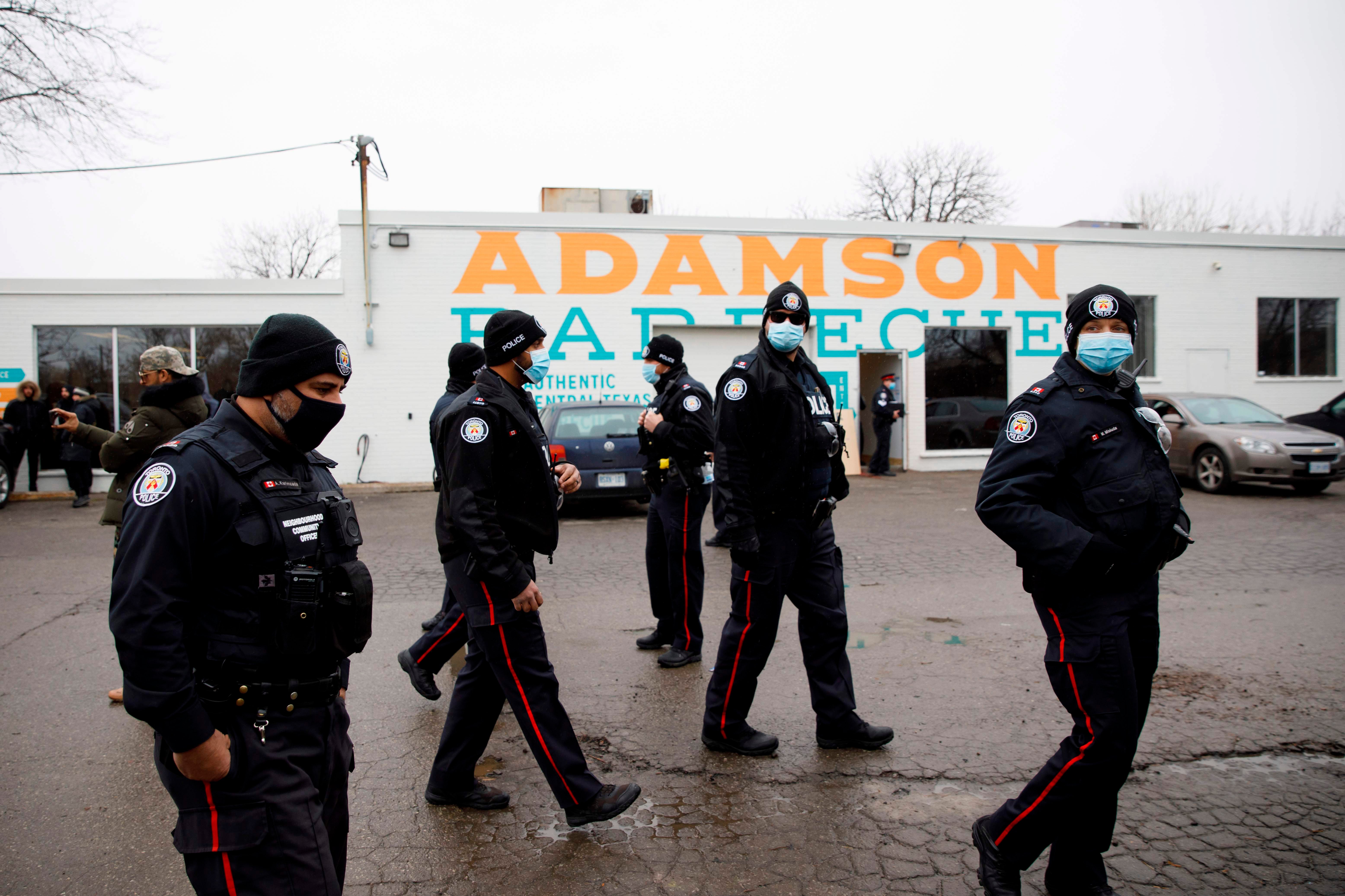 <p>Police gather in the car park of Adamson Barbecue</p>