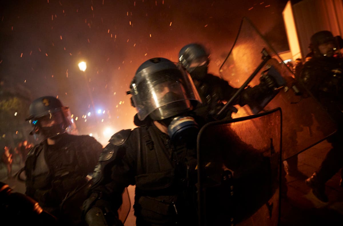 Police tear gas Parisian protesters after tens of thousands demonstrate ...