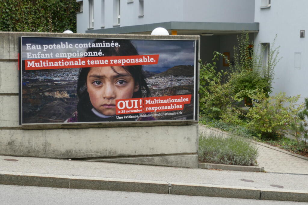 Photo of a campaign sign in Freiburg, Switzerland which reads “ Drinking water in contaminated. The children are poisoned. Multinational organisations are responsible”