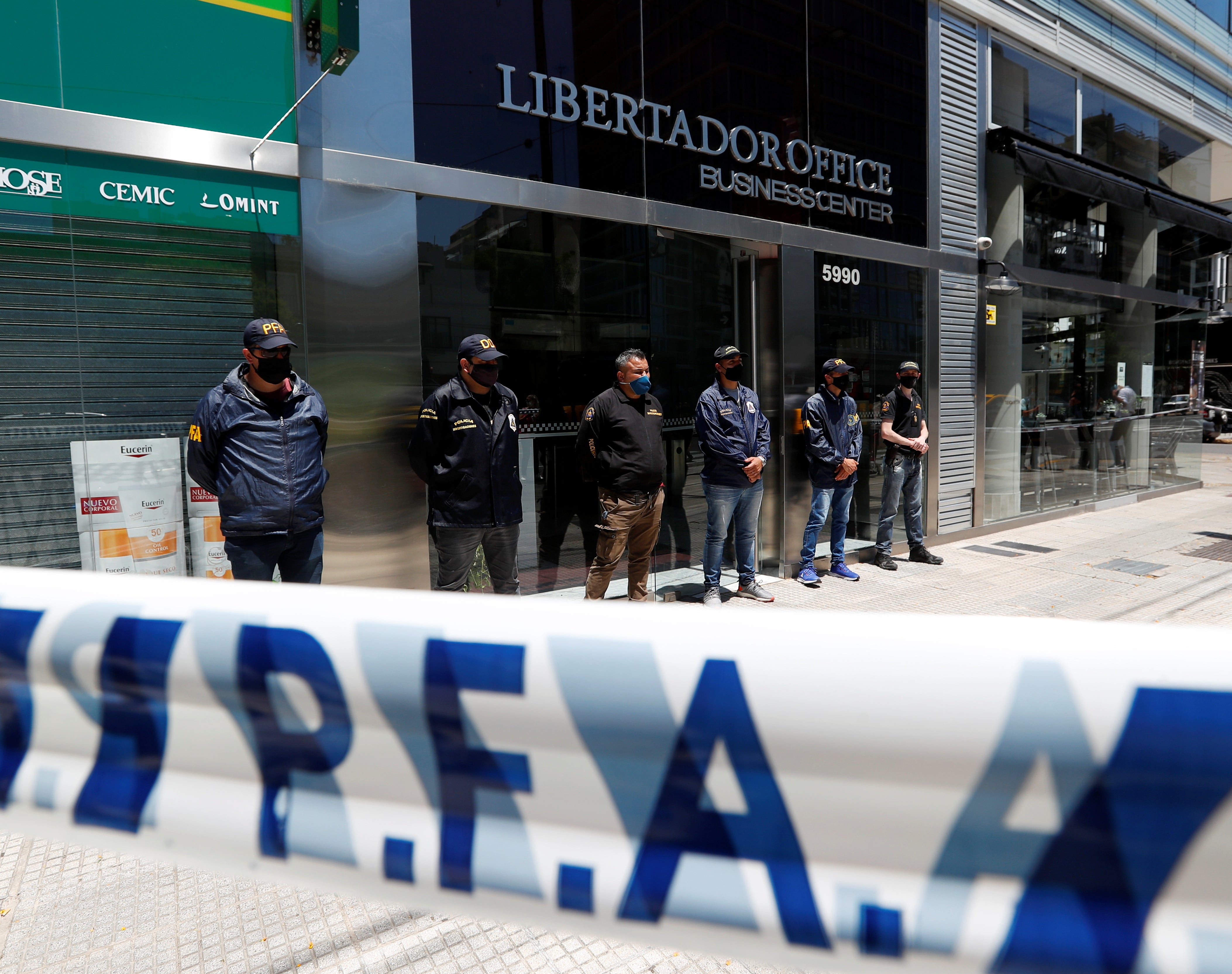 Police stand guard outside the Buenos Aires office of Dr Leopoldo Luque