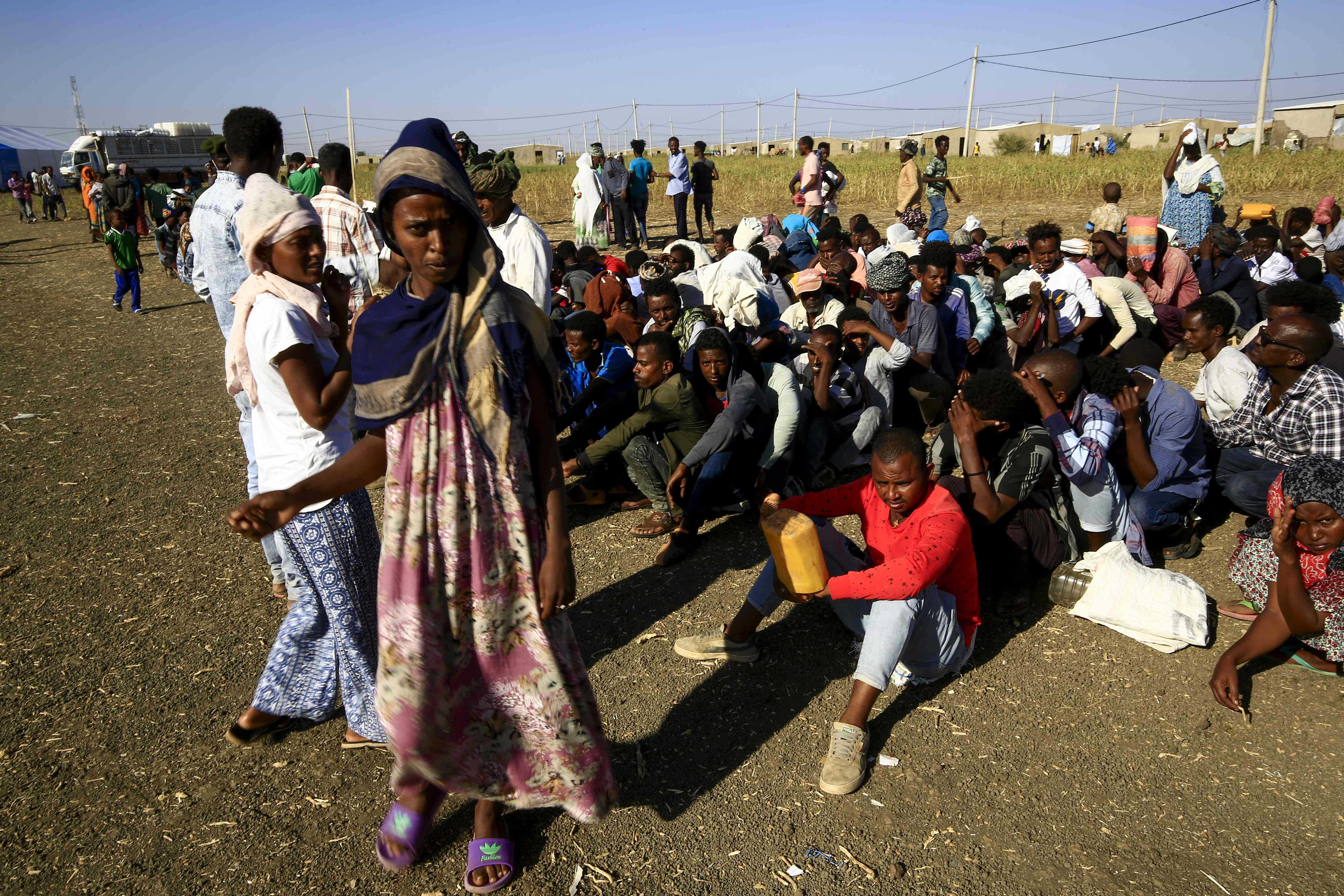 Ethiopian refugees, who fled the fighting in Tigray Region, gather at a border in Gedaref State, eastern Sudan