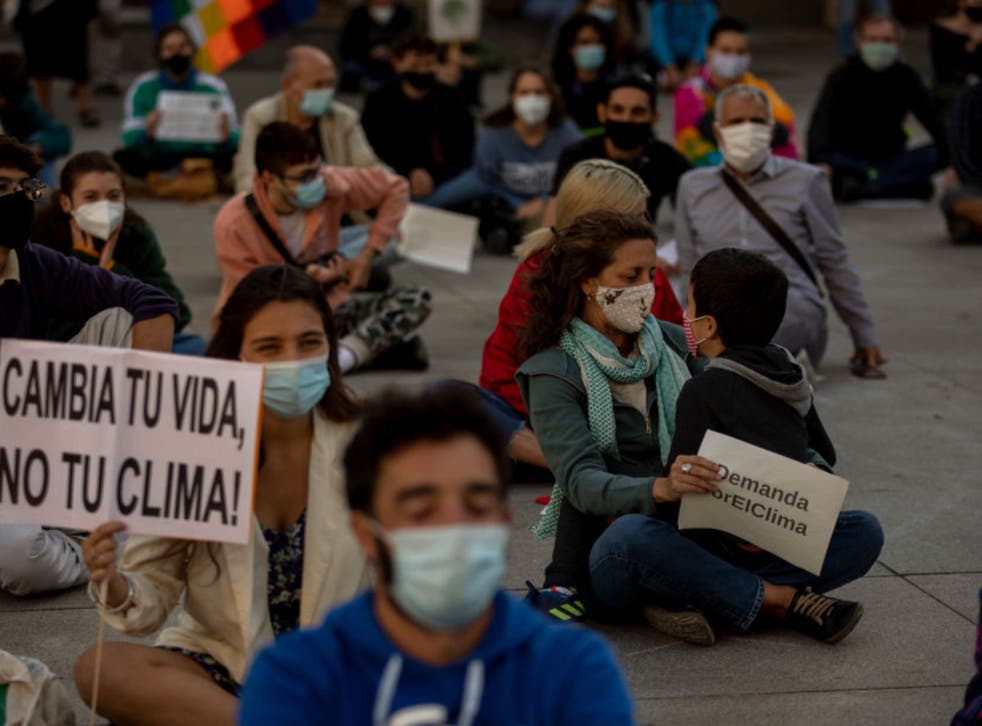 <p>A file image of environmental activists wearing protective face masks and practicing social distancing guidelines during a protest in Madrid in September 2020</p>
