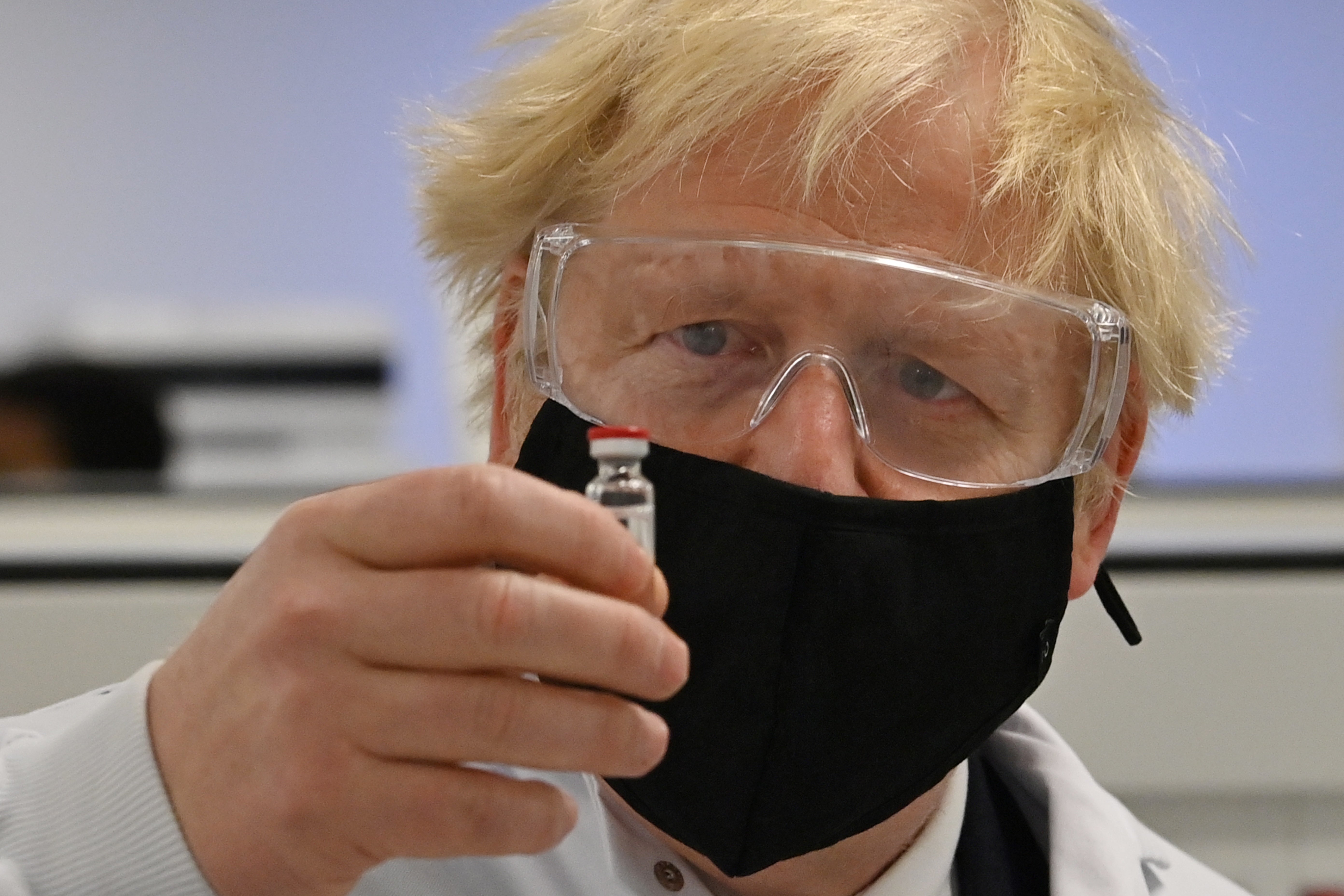 Boris Johnson with a vial of the Oxford-AstraZeneca vaccine