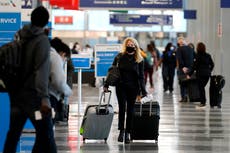 Holiday air travel surges despite dire health warnings