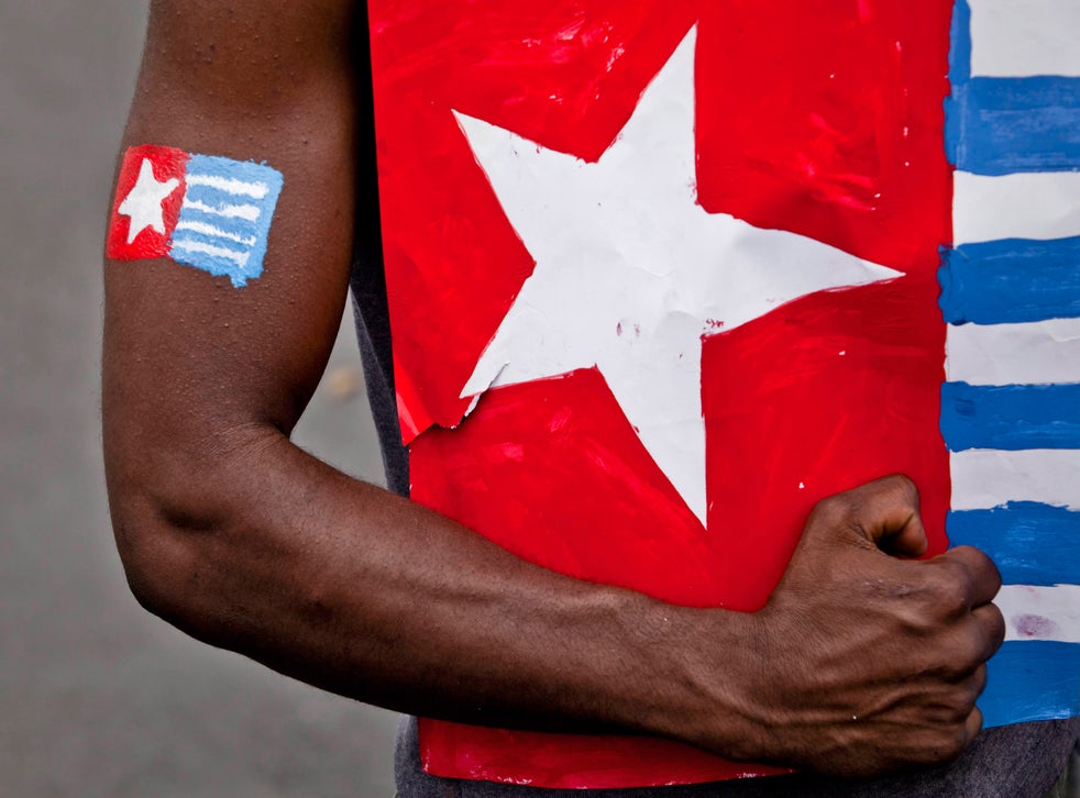 A protester from the Papuan Students Alliance holds the Morning Star flag during a protest on August 15, 2013 in Yogyakarta, Indonesia. Raising the Morning Star flag is illegal in West Papua. 