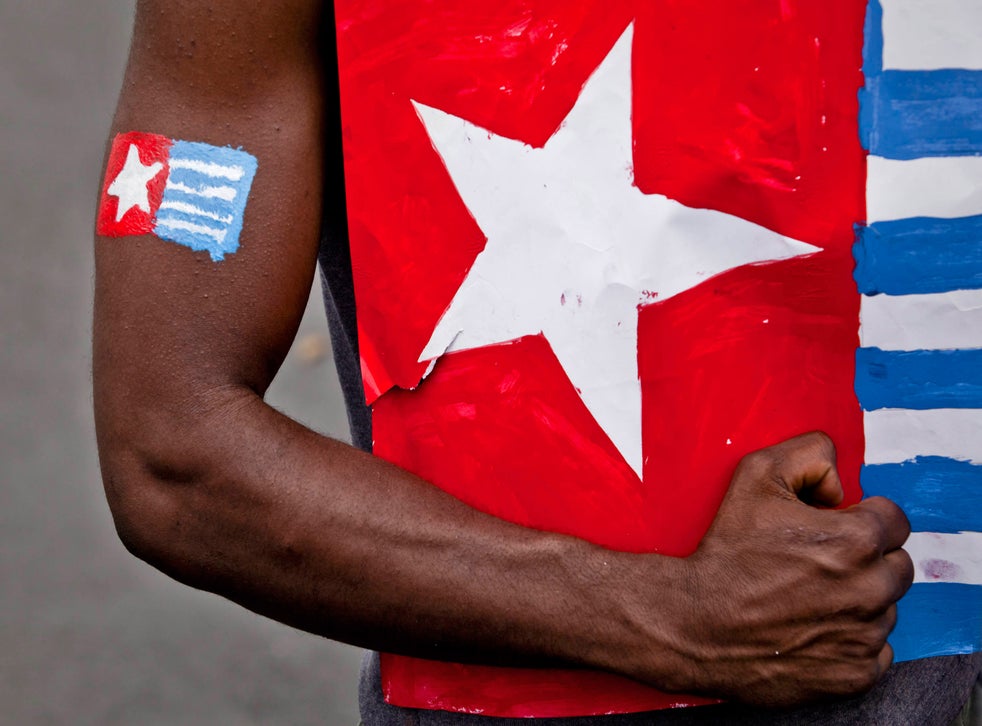 A protester from the Papuan Students Alliance holds the Morning Star flag during a protest on August 15, 2013 in Yogyakarta, Indonesia. Raising the Morning Star flag is illegal in West Papua.
