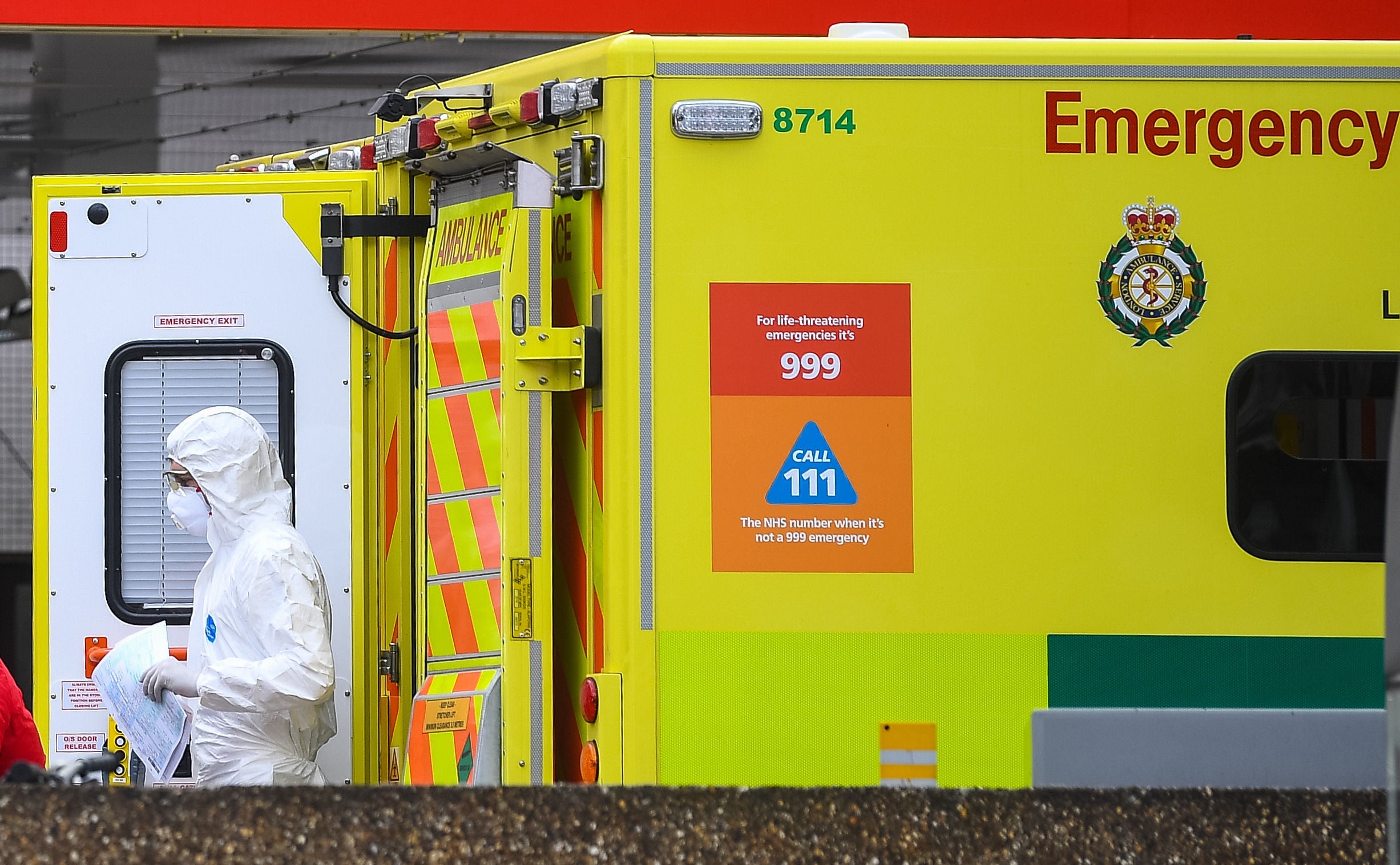 An NHS paramedic wearing personal protective equipment