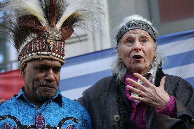 <p>British designer Vivienne Westwood, (R), gestures with West Papua activist Benny Wenda (L) during a protest action to highlight the exploitation of the West Papua rainforest and the continued presence of BP in the area, outside the headquarters of BP in London, on October 18, 2019</p>