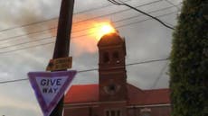 Lightning strike sets heritage bell tower ablaze in Sydney as storm cuts power for tens of thousands