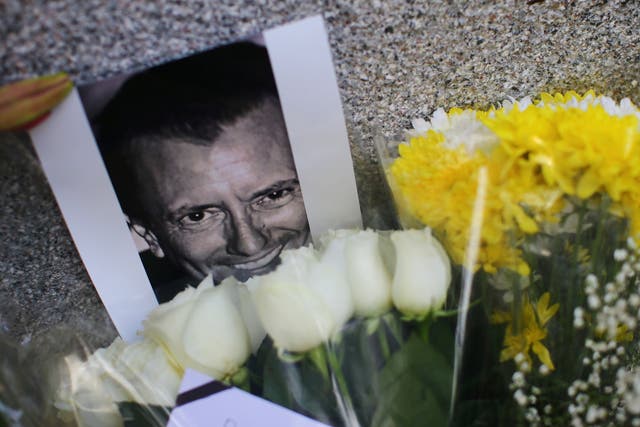 <p>An image of French restaurateur Baptiste Lormand is pictured alongside floral tributes outside the French embassy in Mexico City</p>