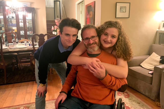 Samuel Kolb, seated, with his son Jacob and daughter Lexi 