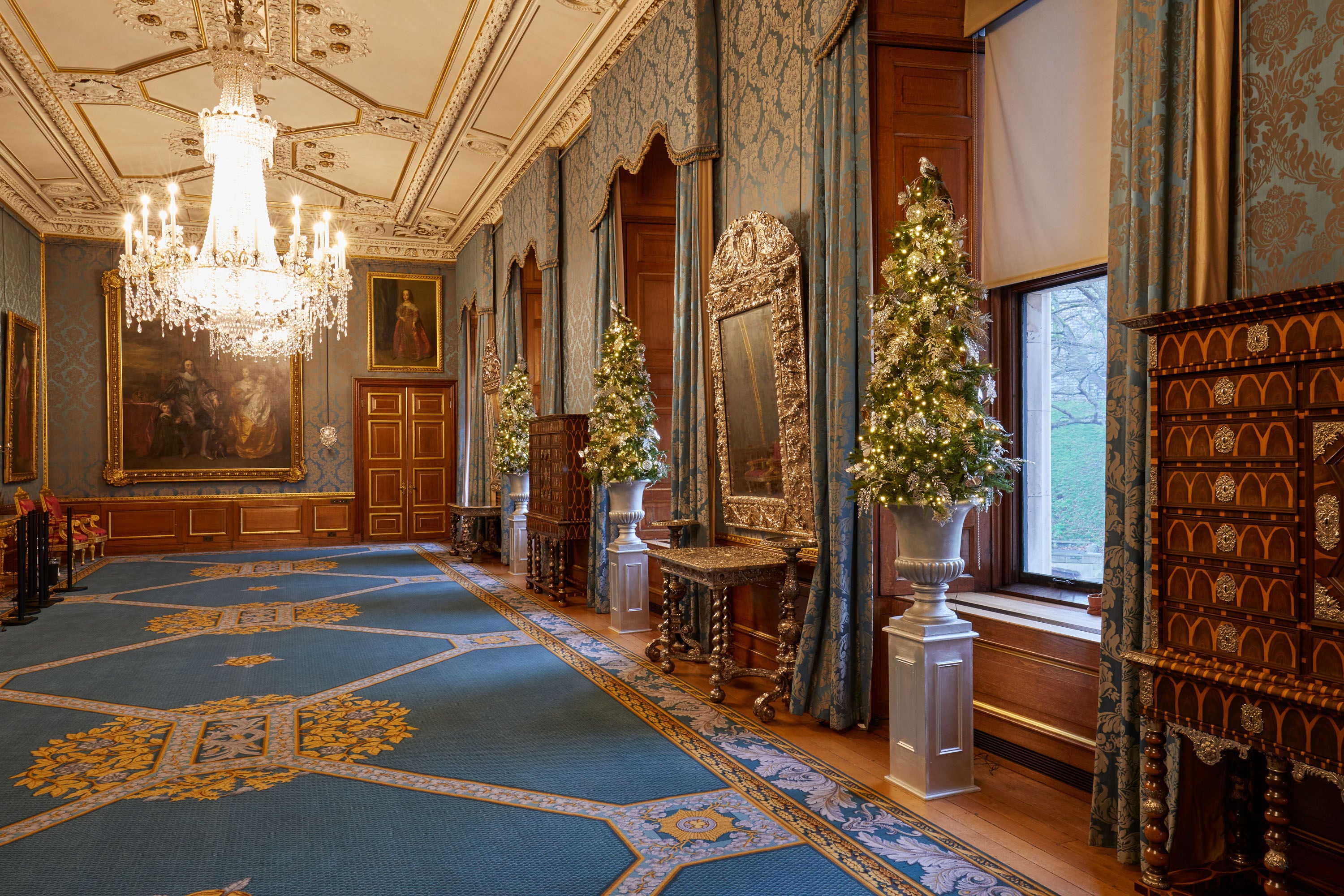 Several smaller Christmas trees line the Queen's Gallery at Windsor Castle