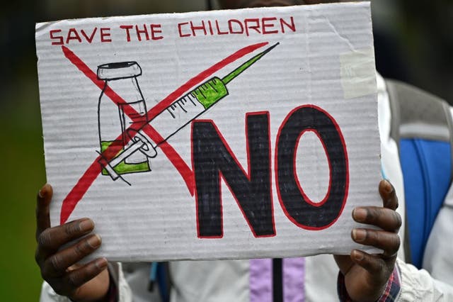 <p>A protester’s placard at a demonstration against vaccinations in London in October</p>