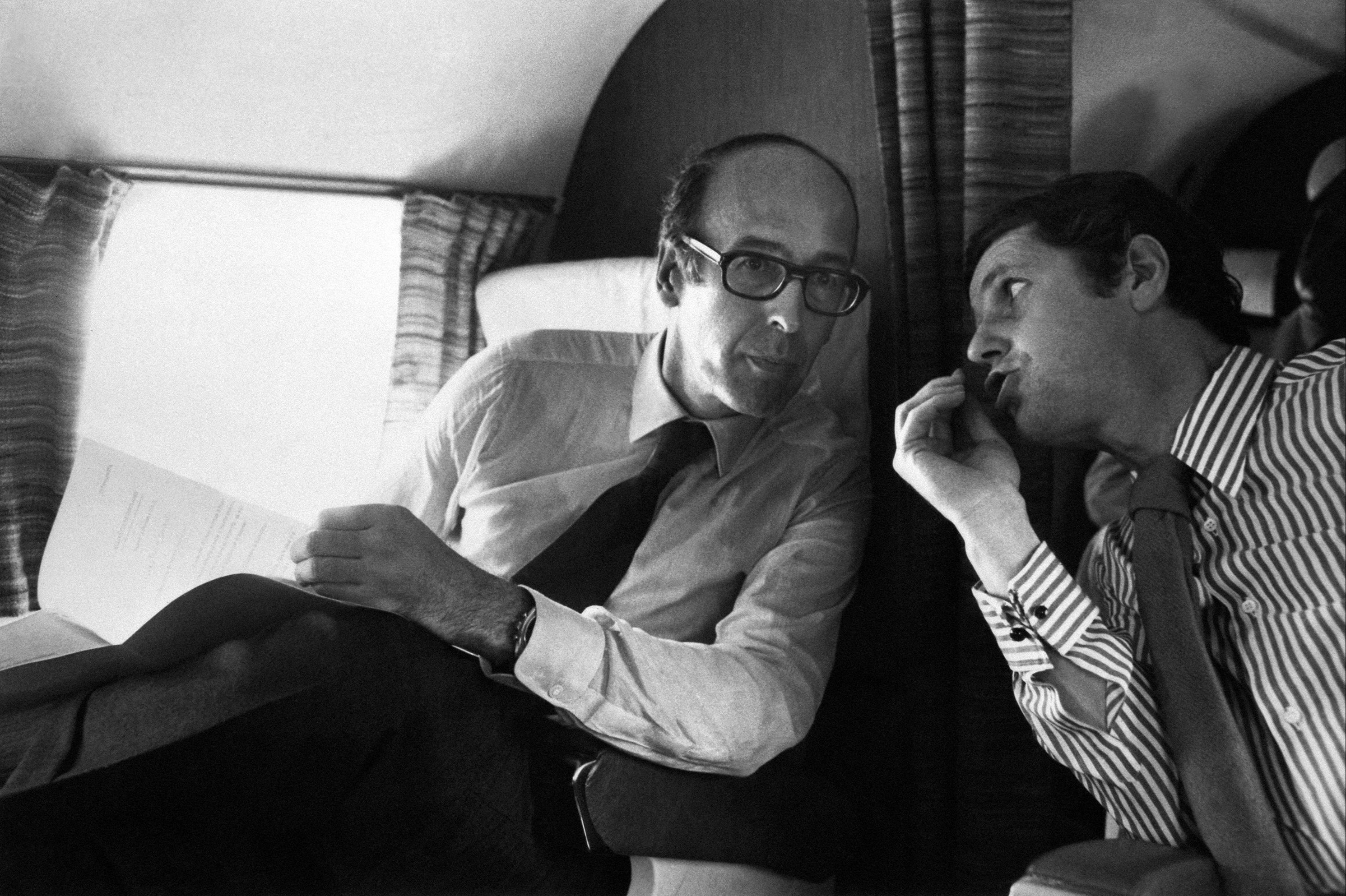 Giscard (left) talks to Olivier Stirn on a plane in 1974