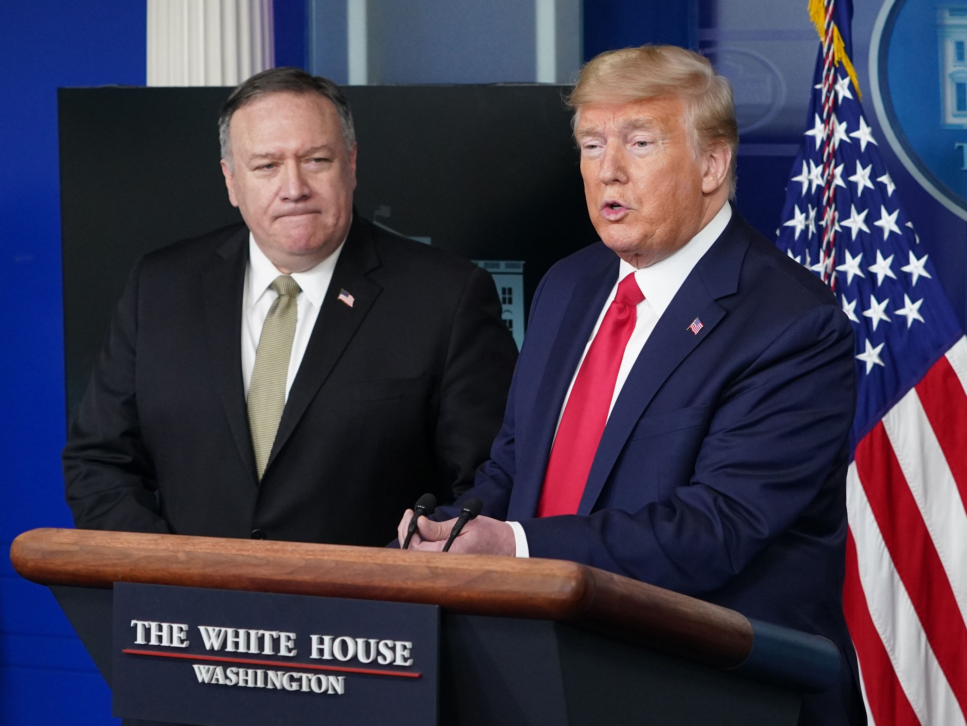 US Secretary of States Mike Pompeo watches US President Donald Trump speak during the daily briefing on the novel coronavirus, in the Brady Briefing Room at the White House on 8 April 2020, in Washington, DC