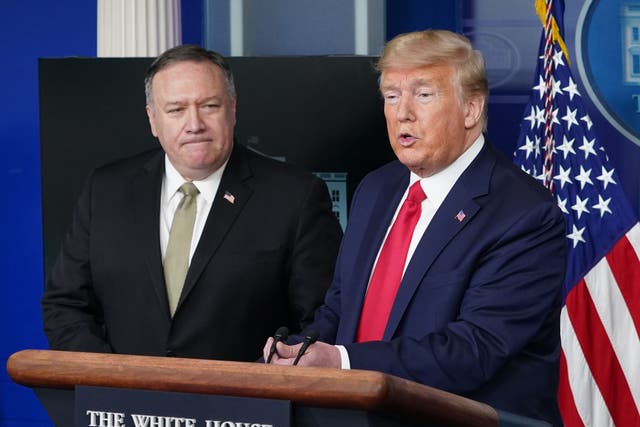 US Secretary of States Mike Pompeo watches US President Donald Trump speak during the daily briefing on the novel coronavirus, in the Brady Briefing Room at the White House on 8 April 2020, in Washington, DC