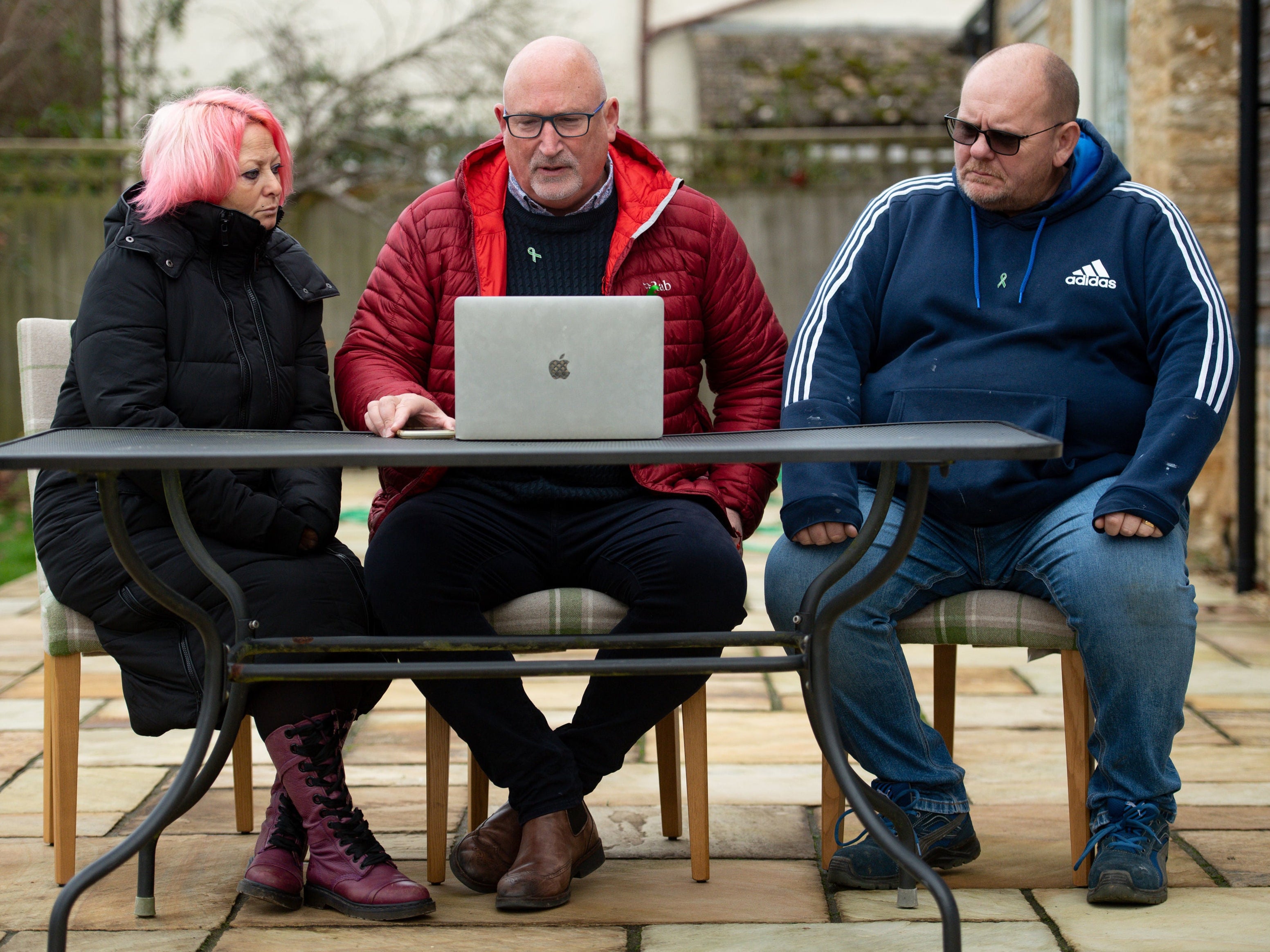 Charlotte Charles and Tim Dunn with family adviser Radd Seiger (centre) at home in Oxfordshire after hearing they had lost their High Court battle