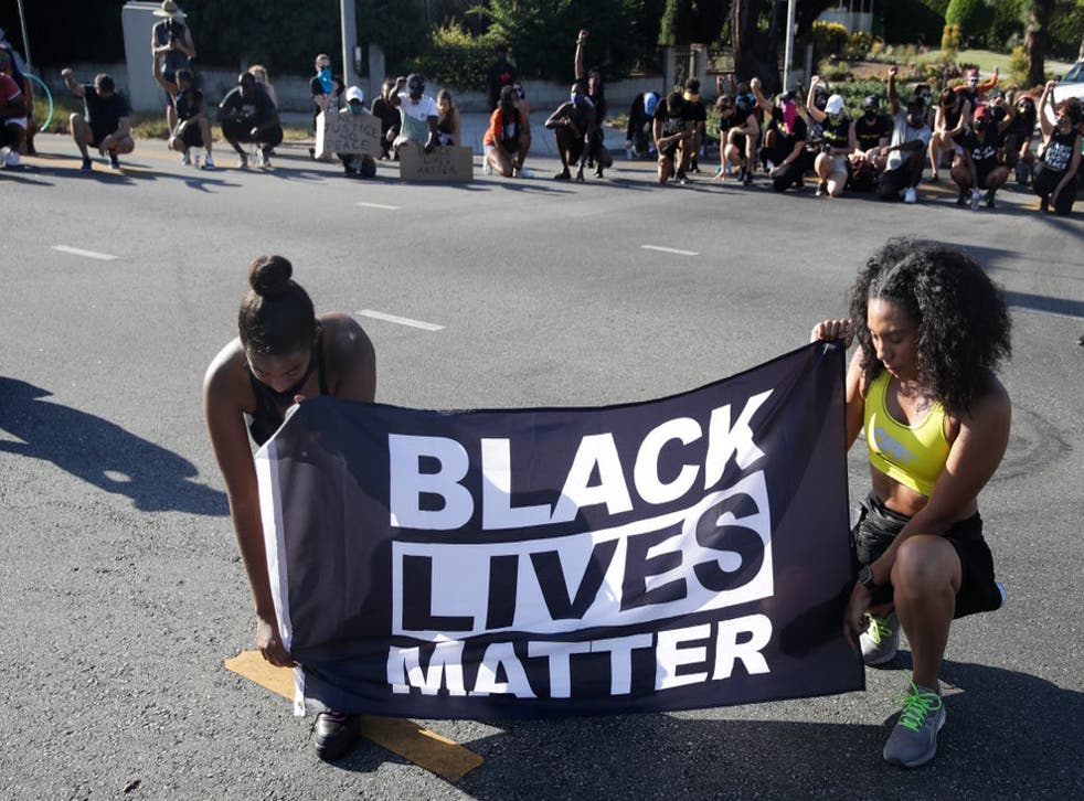 Protesters display a BLM banner