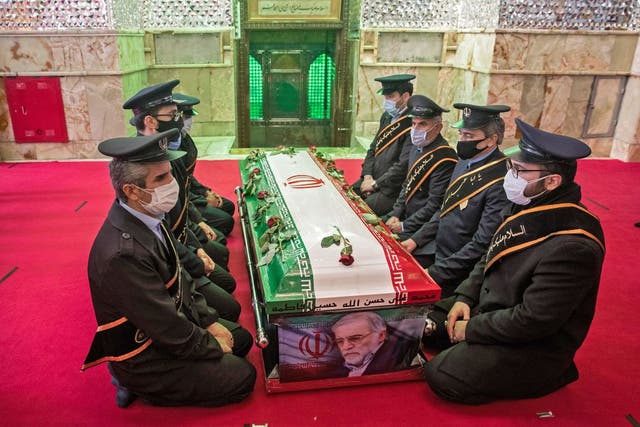 Members of Iranian forces pray around the coffin of nuclear scientist Mohsen Fakhrizadeh