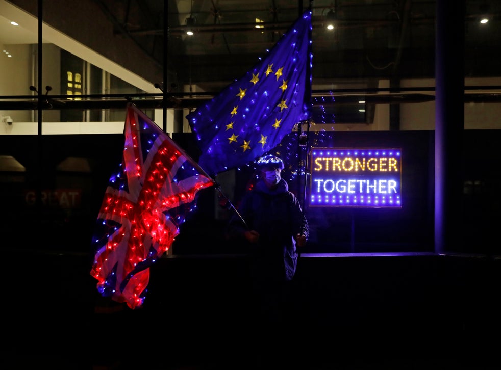 A pro-EU supporter waves flags outside Brexit trade talks