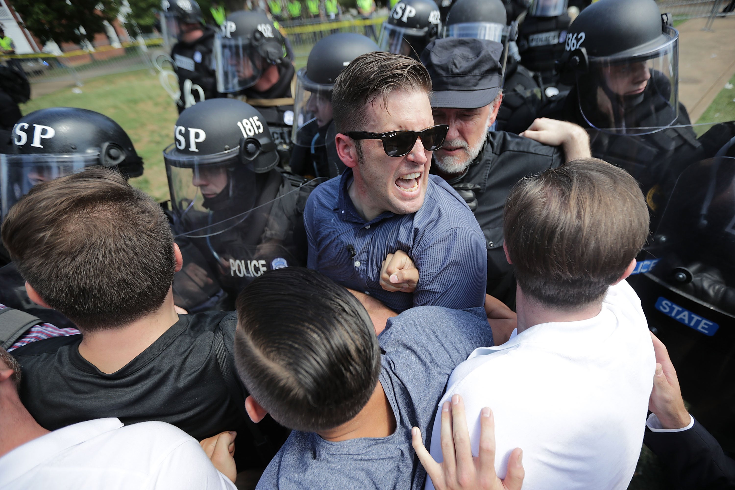 <p>White nationalist Richard Spencer and his supporters clash with Virginia State Police in Emancipation Park after the Unite the Right rally was declared unlawful&nbsp;</p>