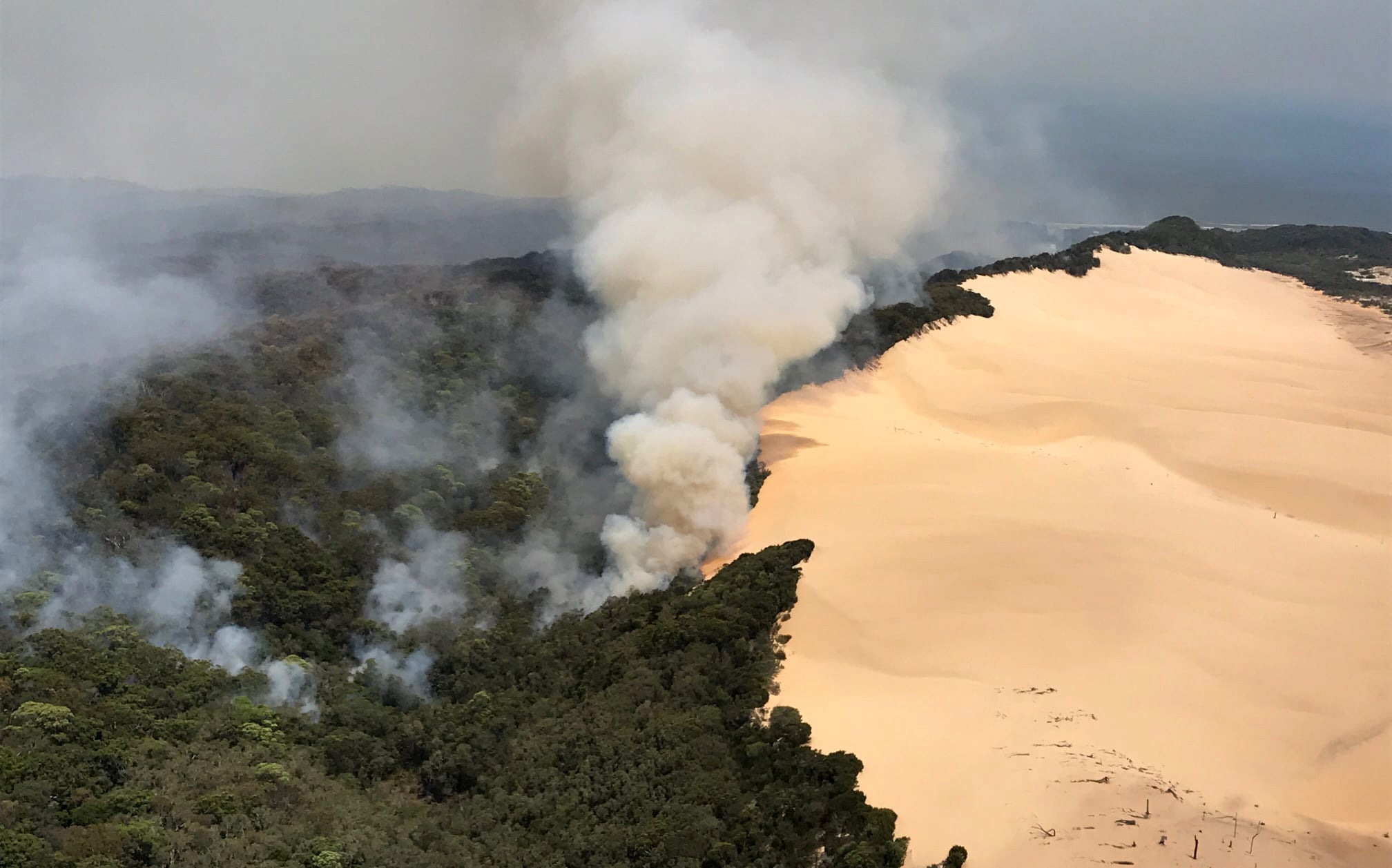 In this handout image provided by Queensland Fire and Emergency Services (QFES), bushfires continue to burn on November 30, 2020 on Fraser Island, Australia.