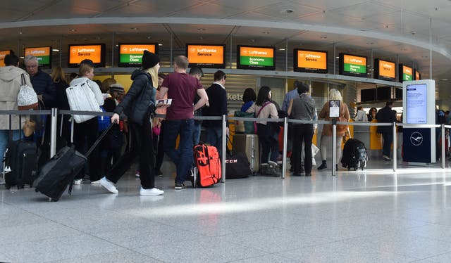 <p>Passengers queue at the Franz Josef Strauss airport in Munich</p>