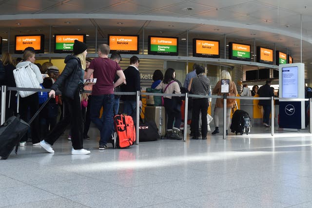 <p>Passengers queue at the Franz Josef Strauss airport in Munich</p>