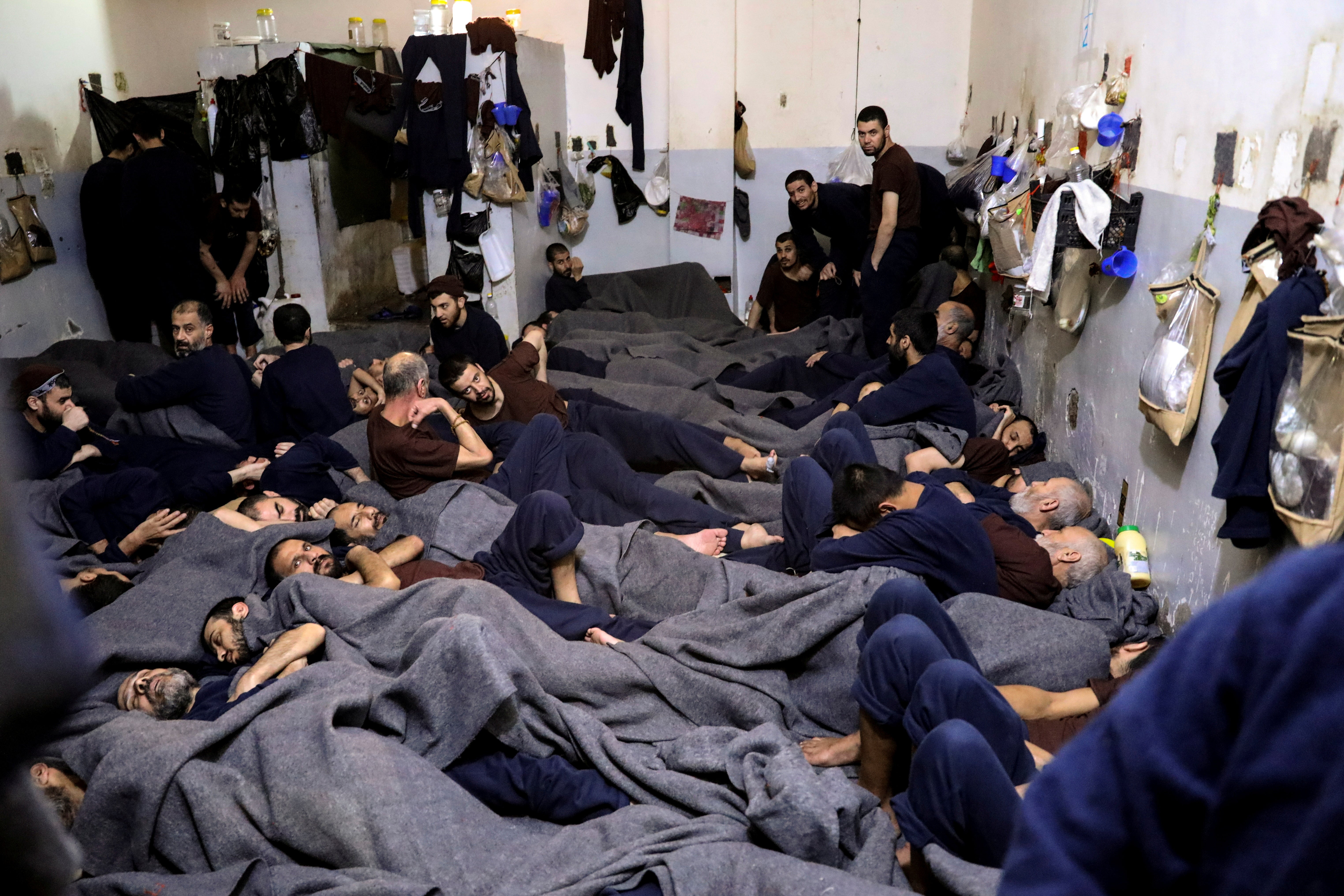 Foreign prisoners, suspected of being part of the Islamic State, lie in a prison cell in Hasaka, Syria, in January