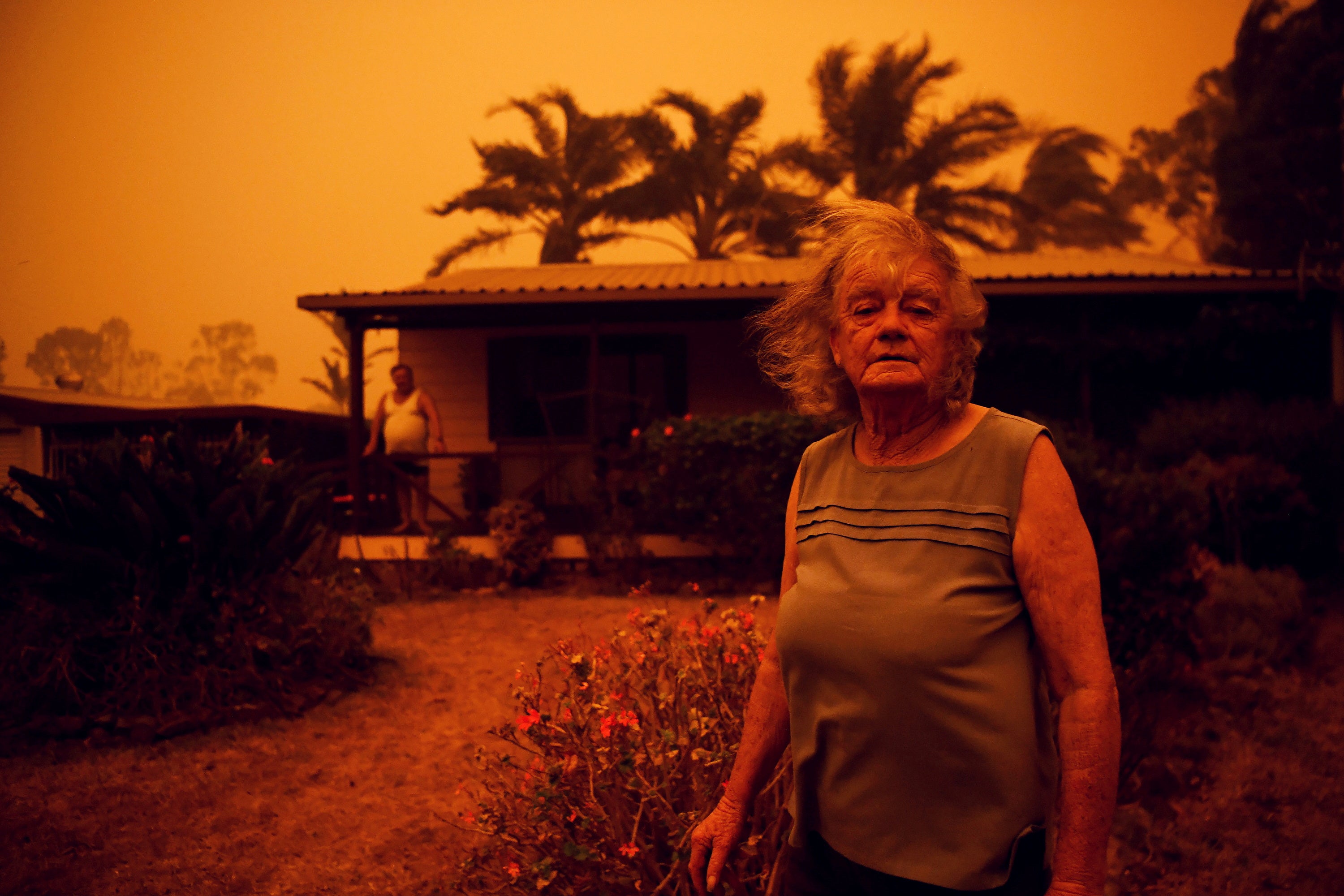 Nancy and Brian Allen outside their home as high winds push smoke and ash from the Currowan Fire towards Nowra, in New South Wales, Australia, in January