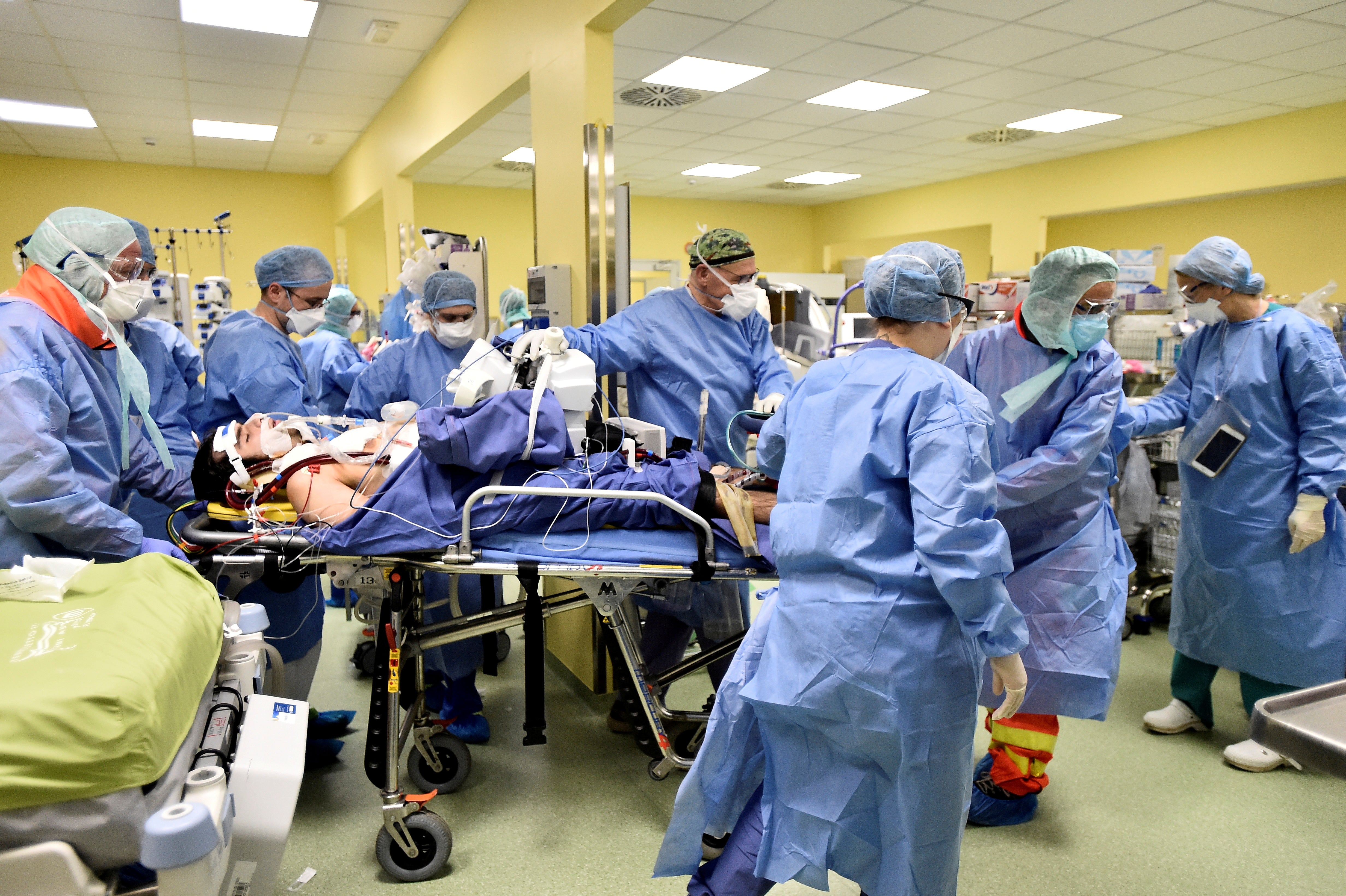 Medical staff move an 18-year-old Covid-19 patient in an intensive care unit at the San Raffaele hospital in Milan, Italy, in March