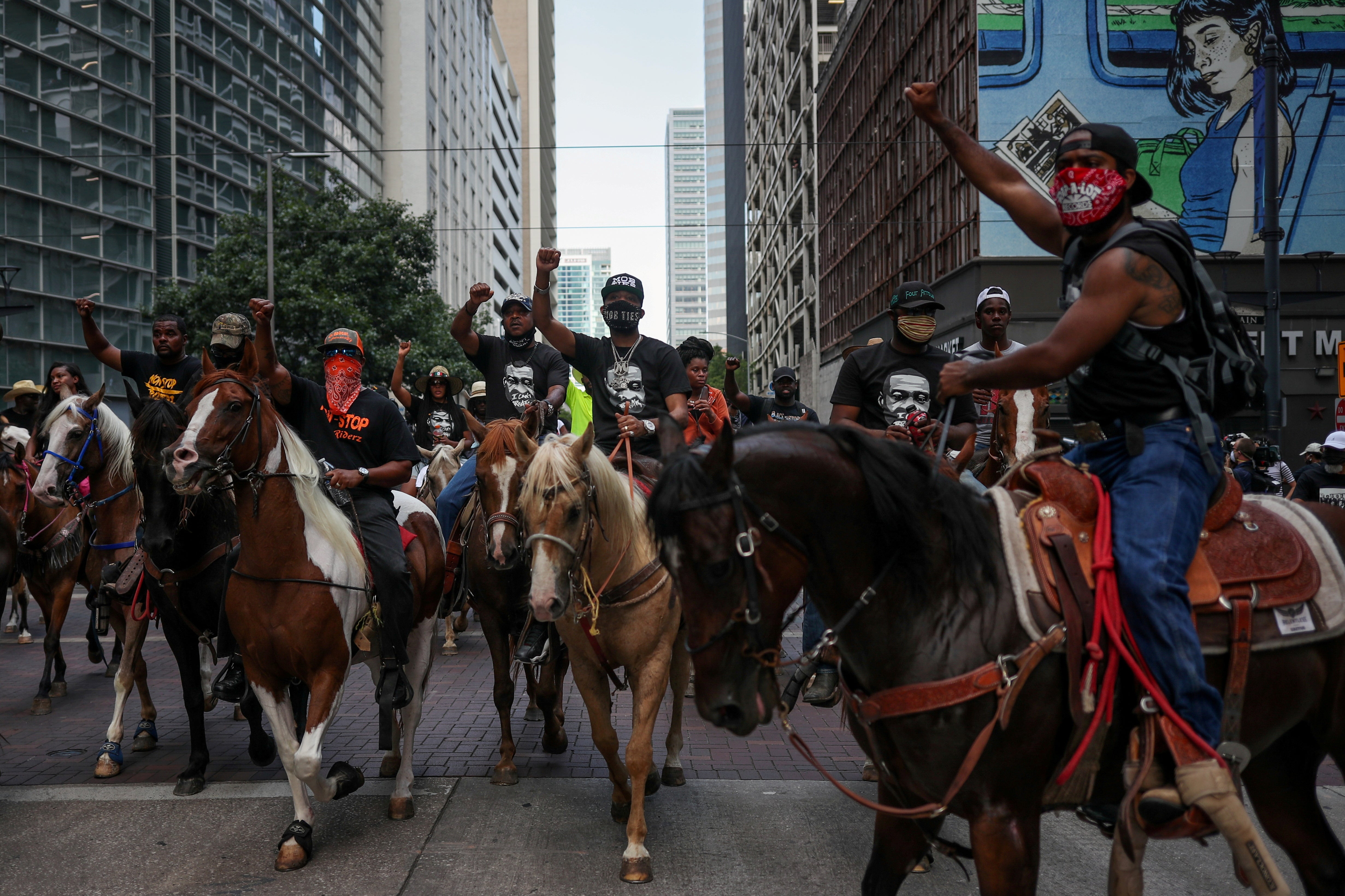 Protesters on horseback in downtown Houston, Texas, rally in June against the murder of George Floyd