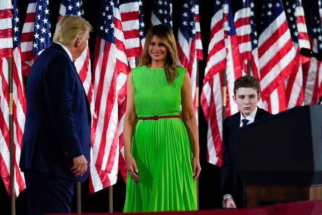 President Donald Trump appears on stage with first lady Melania Trump after he gave a speech from the South Lawn of the White House on the fourth day of the Republican National Convention, Thursday 27 August 2020, in Washington. Barron Trump is at right