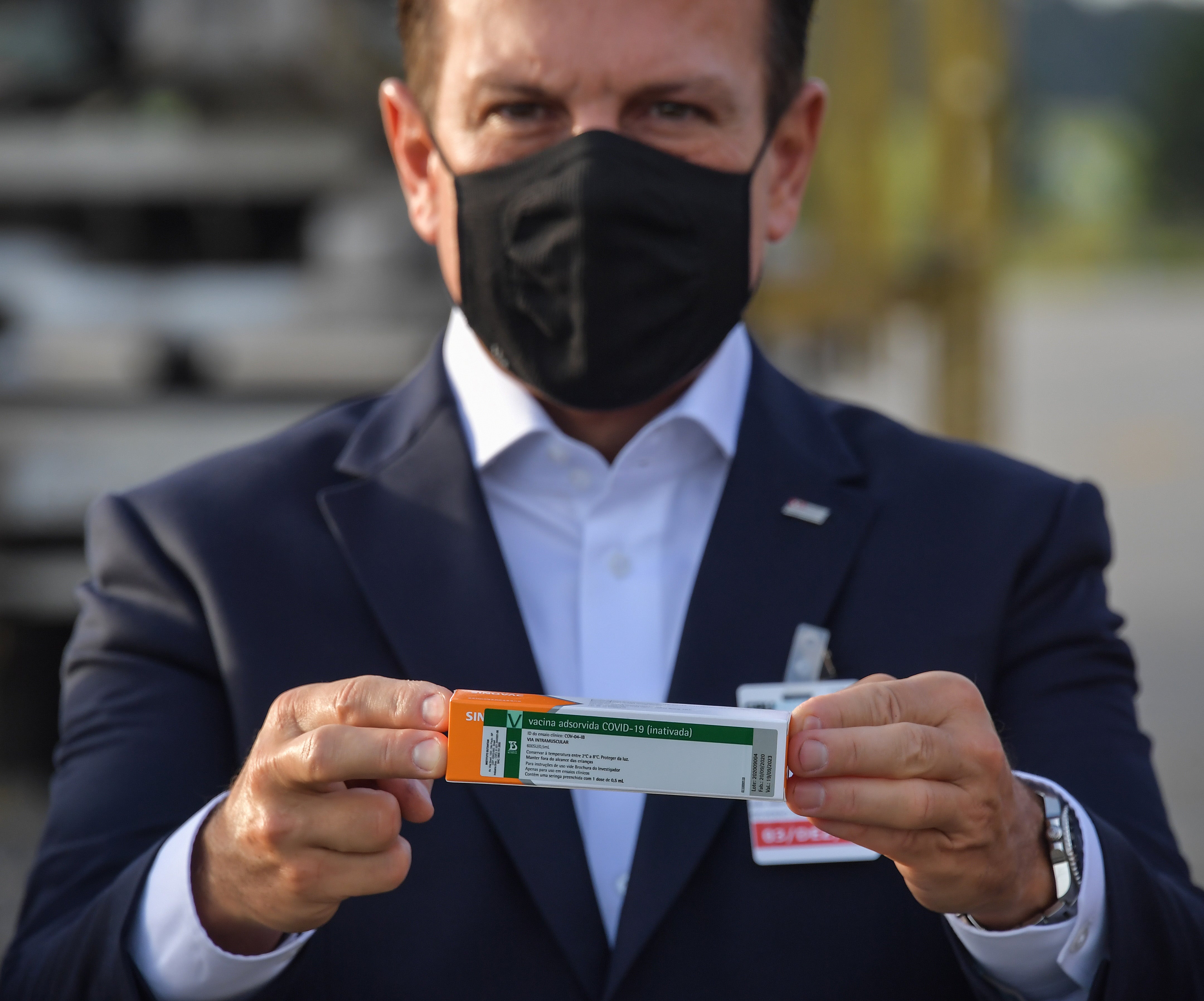 Joao Doria holds a package of the CoronaVac vaccine