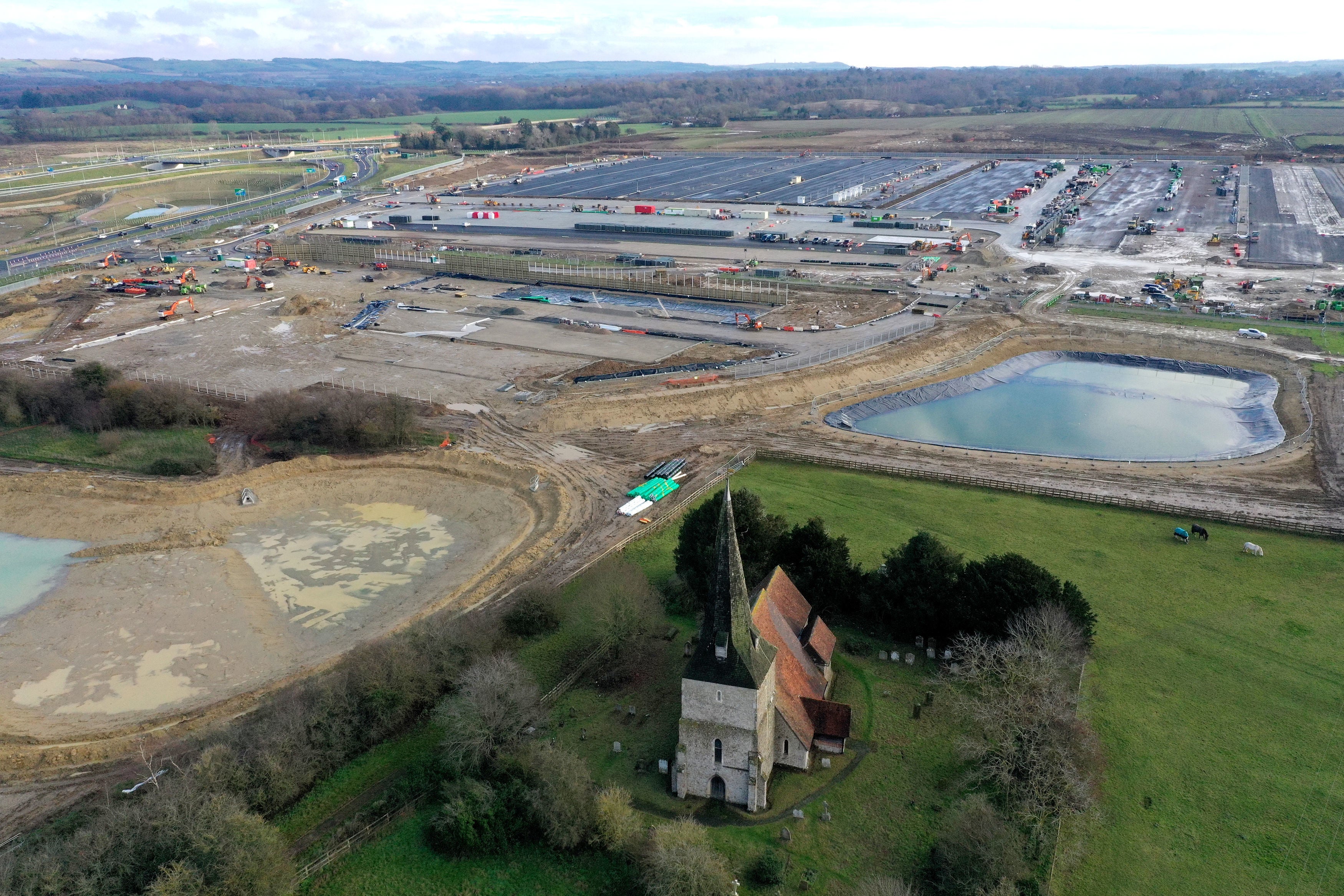 A view of St Mary’s Church and the construction work at the neighbouring Sevington inland border facility in Ashford, Kent on 6 November, 2020.