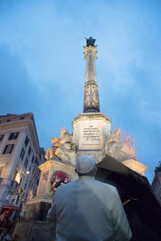 Pope makes surprise early morning prayer visit in rainy Rome
