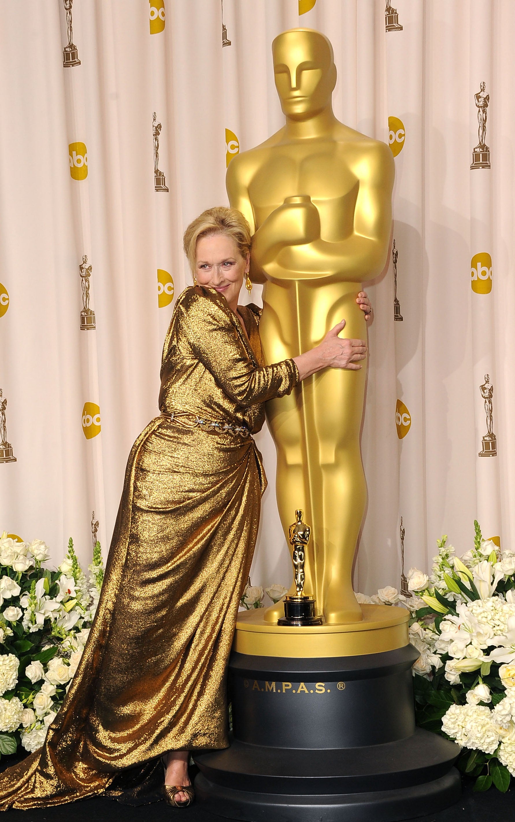 Streep hugs an Oscar statue in 2012