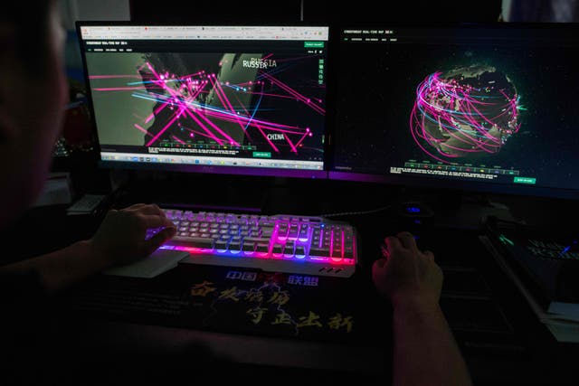 In this file photo taken in August, a member of a hacking group uses a website that monitors global cyberattacks